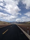 long road in the middle of a desert landscape with mountains Royalty Free Stock Photo