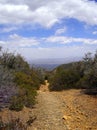 View looking back down a hiking trail toward a valley below