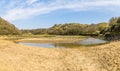 A view looking back from Three Cliffs Bay along Pennard Pill stream towards the castle ruins, Gower Peninsula, South Wales Royalty Free Stock Photo