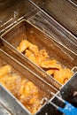 fried chicken inside deep fryer basket Royalty Free Stock Photo