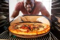 View Looking Out From Inside Oven As Man Cooks Fresh Pizza Royalty Free Stock Photo