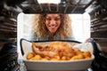 View Looking Out From Inside Oven As Woman Cooks Sunday Roast Chicken Dinner Royalty Free Stock Photo