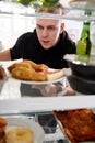 View Looking Out From Inside Of Refrigerator Filled With Unhealthy Takeaway Food As Man Opens Door Royalty Free Stock Photo