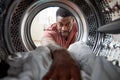 View Looking Out From Inside Washing Machine As Man Does White Laundry Royalty Free Stock Photo