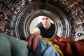 View Looking Out From Inside Washing Machine As Young Man Does Laundry Royalty Free Stock Photo