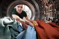 View Looking Out From Inside Washing Machine As Young Man Does Laundry Royalty Free Stock Photo