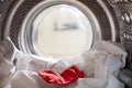 View Looking Out From Inside Washing Machine With Red Sock Mixed With White Laundry