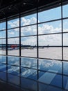 View looking out to airport with aircraft, blue sky and clouds Royalty Free Stock Photo