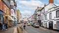 View looking up Broad Street, decorated with colourful bunting and Union Jack flags in Lyme Regis, Dorset, U
