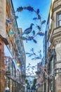 View looking up at the Christmas lights in Slingsby Place off Long Acre in London