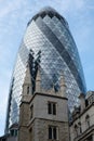 View looking up at the iconic Gherkin Building, London UK. Church of St Andrew Undershaft is in the foreground. Royalty Free Stock Photo