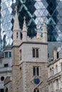 View looking up at the iconic Gherkin Building, London UK. Church of St Andrew Undershaft is in the foreground. Royalty Free Stock Photo