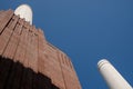 Chimneys at Battersea Power Station, renovated interwar building, now a mixed use retail and residential scheme.