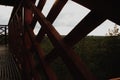 View through the lookout tower wooden security fence fence windows to the forest on a foggy autumn morning. distant horizon. spruc