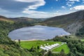 View on Lough Tay with a movie set related to Viking era with longships and village