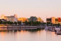 View of the Louise Basin with moored sailboats and buildings in the background during a golden hour dawn Royalty Free Stock Photo