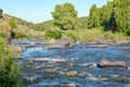 View from a low point on the waters of a mountain river with turbulent surface Royalty Free Stock Photo