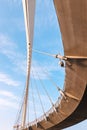 View from lower angle of the suspension pedestrian bridge. Interesting geometry of an engineering project Royalty Free Stock Photo