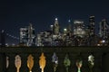 View of lower Manhattan and Financial district at night. Skyscrapers with lights on in New York City seen above columns of Royalty Free Stock Photo