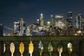 View of lower Manhattan and Financial district at night. Skyscrapers with lights on in New York City seen above columns of Royalty Free Stock Photo