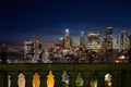 View of lower Manhattan and Financial district at night. Skyscrapers with lights on in New York City seen above columns of Royalty Free Stock Photo