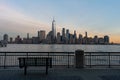 Lower Manhattan New York City Skyline seen from the Jersey City Waterfront with a Bench during a Sunset