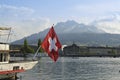 View of Lucerne from lake Lucerne and Switzerland flag Royalty Free Stock Photo