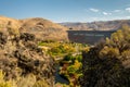 View of Lucky Peak Dam on the Boise River with fall colors and cliffs above Royalty Free Stock Photo