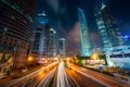 View of Lujiazui Business district skyscraper with traffic in street at night in Shanghai, China. Asian tourism, modern city life