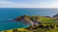 A view of the Lulworth Cove along the Jurrassic Coast in Dorset under a majestic blue sky and some white clouds Royalty Free Stock Photo