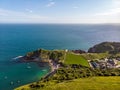 A view of the Lulworth Cove along the Jurrassic Coast in Dorset under a majestic blue sky and some white clouds Royalty Free Stock Photo