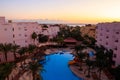 View of luxurious hotel with a swimming pool and Red sea at sunrise Royalty Free Stock Photo