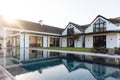 View of luxurious modern house exterior with garden and swimming pool Royalty Free Stock Photo