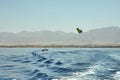 The view from the luxury yacht to the open red sea with the attraction flying on a parachute tied to a boat Royalty Free Stock Photo