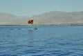 The view from the luxury yacht to the open red sea with the attraction flying on a parachute tied to a boat Royalty Free Stock Photo