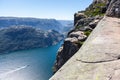 View at Lysefjord and huge Preikestolen cliff on Kjerag mountain. Passenger ship floats from Lysebotn village. Visitors hike to Pu Royalty Free Stock Photo