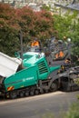 View of machinery and workers laying new bitumen on a suburban road near Hobart Royalty Free Stock Photo