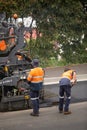 View of machinery and workers laying new bitumen on a suburban road near Hobart Royalty Free Stock Photo