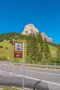 View of magical granite Dolomite peak, Sassongher, alpine pine and spruce forests, green valleys and a post sign showing direction Royalty Free Stock Photo