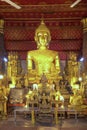 View of main Buddha image in seated meditation pose at Wat Mai Suwannaphumaham, a Buddhist temple in Luang Prabang, Laos