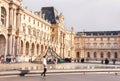 View of main courtyard of Louvre Museum with pyramid.