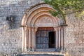 View of the main entrance to the church of Santa Maria de Siurana, in Siurana, Tarragona, Spain. Copy space for text. Royalty Free Stock Photo