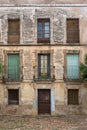 View of the main facade of an old building in ruins, with numeral 1 on the door, in the historic center of Cuidad Rodrigo downtown Royalty Free Stock Photo