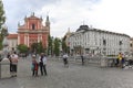 View of the main square of Ljubljana and Ljubljana Cathedral and several tourists passing by