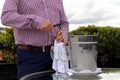 View male hands opening bottle of sparkling white wine in cooler and crystal glasses Royalty Free Stock Photo