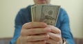 View of a man Counting Many American 100 bills, Man not happy about not having enough money. Slowmotion. Royalty Free Stock Photo