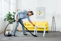 View of man in headphones cleaning