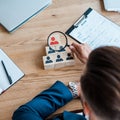 View of man holding magnifier near wooden cubes