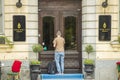 View of man with luggage on doorsteps of hotel. Business and tourism concept.