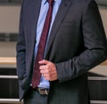 View of a man posing in a blue shirt leaning on the wall - professionalism concept